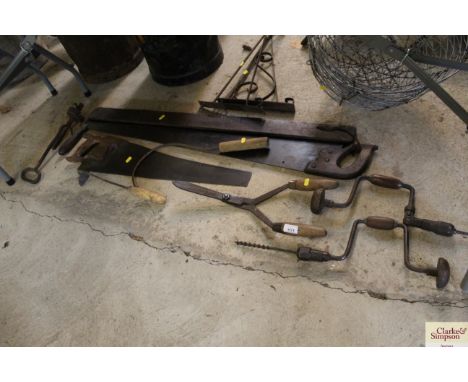 A quantity of tools including saws, two braces, shears etc.