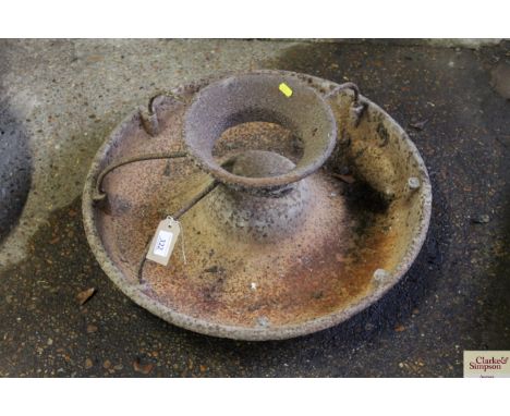 A circular cast iron pig trough with some sections 