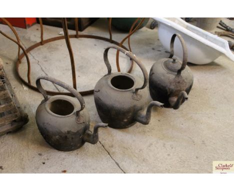 Three vintage cast iron kettles, one with lid 
