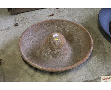 A cast iron circular pig trough 