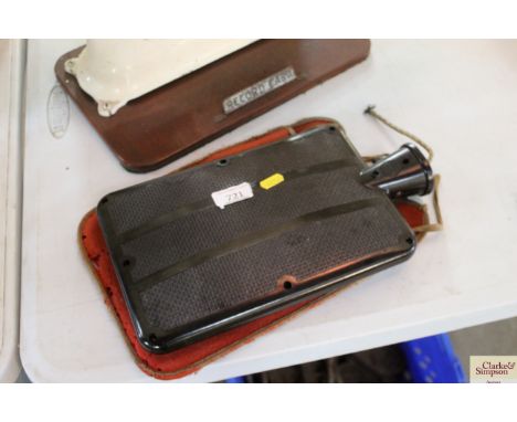 A vintage electric Bakelite hot water bottle and cover - sold as a collector's item