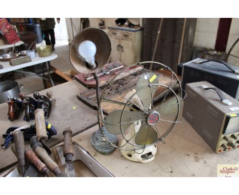 A vintage electric fan and a desk lamp - sold as collector's items