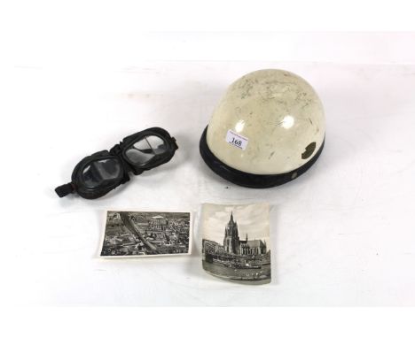 A vintage motor cycle helmet, goggles and two post-cards 