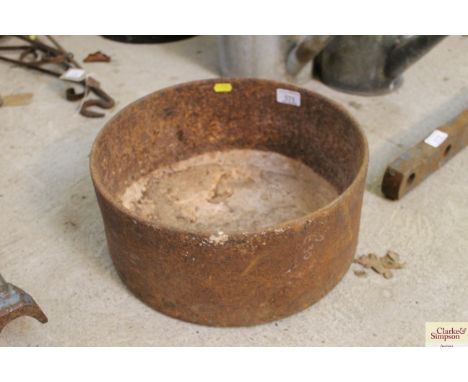 A small circular cast iron feeding trough 