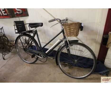 A ladies Elswick Raleigh cycle, with stainless steel wheels, child's seat and front basket