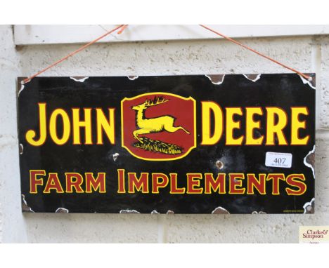 A reproduction "John Deere Farm Implement" enamel sign, approx. 17½" x 8½"