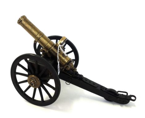 A gilt and patinated metal and wood working scale model of a late-19th century American Gatling gun, with brass barrel, metal