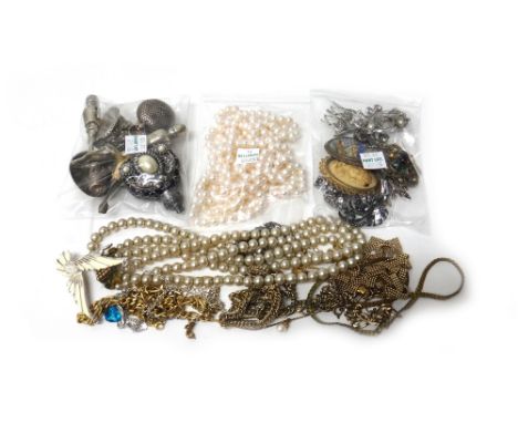 A gilt metal long guard chain, a silver charm bracelet, two stick pins, a silver mounted reconstituted amber pendant, a silve