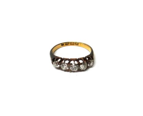 An 18ct gold and diamond set five stone half hoop ring, mounted with a row of slightly graduated cushion shaped diamonds, Che