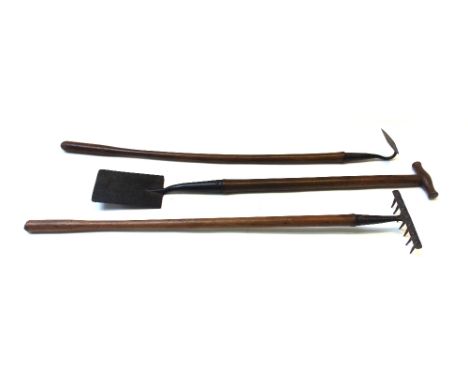 A set of three novelty child's gardening tools, late 19th/early 20th century, steel with wooden handles, comprising a spade, 