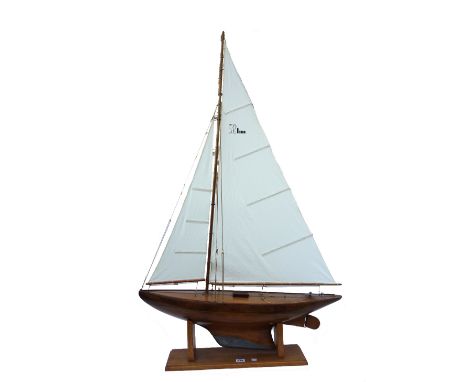 A wooden scale model pond yacht, mid-20th century, possibly Basset-Lowke, fully rigged with lead keel, on an oak stand, the b