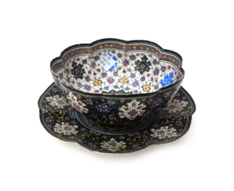 An enamel lobed bowl and stand, probably Indian, late 19th/early 20th century, each painted in the centre with birds in branc