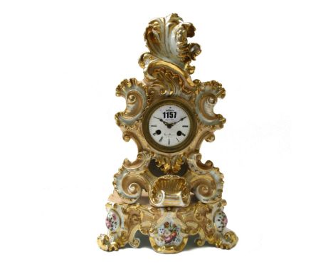 A French porcelain mantel clock, late 19th century, of gilt scroll form, on a foliate decorated base, with silk suspension an