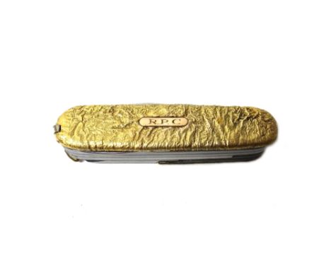 A 9ct gold mounted Swiss Army style folding pocket knife, decorated with a cast finish applied with an initial engraved plaqu