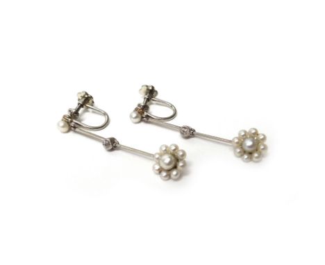 A pair of platinum and white gold, diamond and seed pearl set pendant earrings, each with a seed pearl cluster drop, a seed p