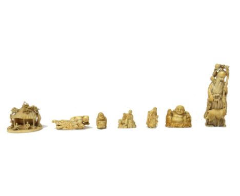 A group of ivory carvings, late 19th/early 20th century, comprising; a small group of two figures seated before a building, 6