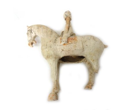 A pair of Chinese pottery models of male and female figures seated on horses, Tang dynasty, the female wearing a large helmet