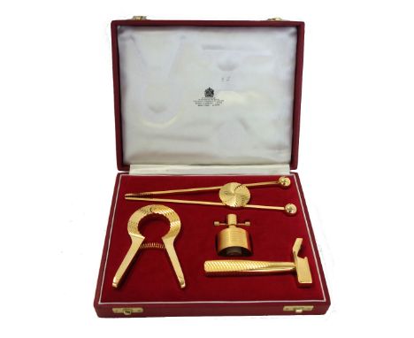 An 'Asprey' gilt metal four piece bottle opening set in a fitted case and box, a 'Screwpull' champagne star, a brass cigar cu
