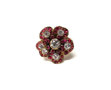 A gold, diamond and synthetic ruby ring, designed as a flowerhead, mounted with the principal cushion shaped diamond at the c