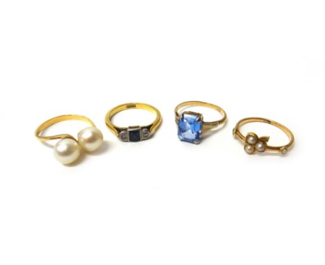 A gold, sapphire and diamond set three stone ring, detailed 18 CT, a gold and pale blue gem set ring, detailed 9 CT, a gold r