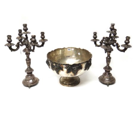 A pair of European five light table candelabra, each with scrolling arms, decorated drip pans and raised on circular bases, w