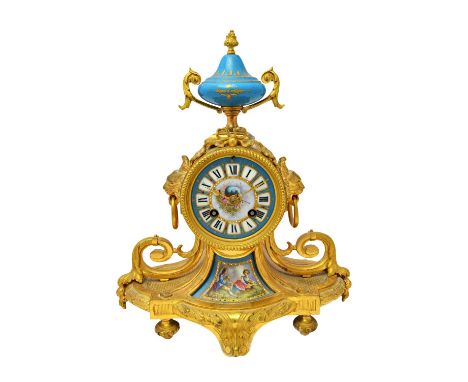 A French ormolu and porcelain mantel clock of Louis XVI design, circa 1880, the drum case with urn finial flanked by lion mas