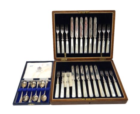 A set of twelve pairs of silver dessert or fruit knives and forks, with engraved decoration and with mother of pearl handles,