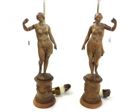 A pair of carved beechwood figures of Venus, late 18th century, later adapted to lamps, 53cm high excluding light fitments. (