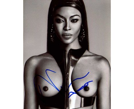 CAMPBELL NAOMI: (1970- ) British Model. Signed 8 x 10 photograph of Campbell, the image showing the top model standing in an 