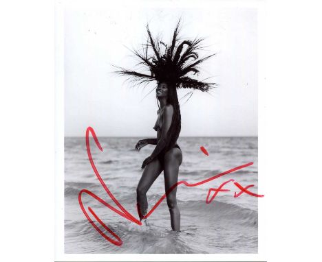 CAMPBELL NAOMI: (1970- ) British supermodel. Signed 8 x 10 photograph of Campbell standing in a full-length topless pose at t