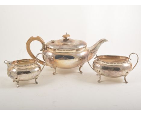Silver three piece teaset, Cooper Brothers & Sons, Sheffield, 1930, comprising boat shaped teapot, sugar basin and jug, raise