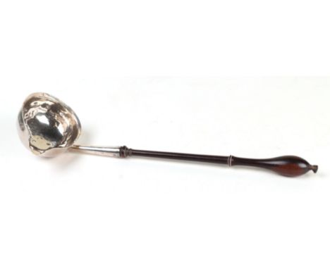 A Georgian silver toddy ladle with turned wooden handle with indistinct London hallmarks, initialled, 29cms long.