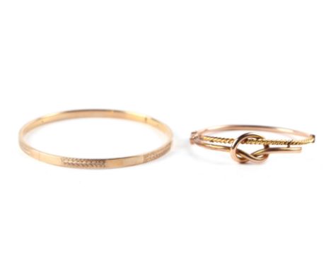 A 9ct gold knot twist bangle, 8g, cased; together with another 9ct gold bangle, 10g, cased (2).Condition ReportThe round bang