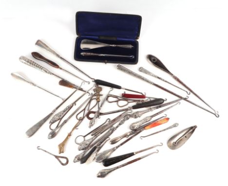 A large collection of button hooks to include silver handled examples.