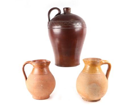 A Bellarmine stoneware salt glazed jug with incised decoration, approx 40cms high; together with two Verwood Pottery jugs eac