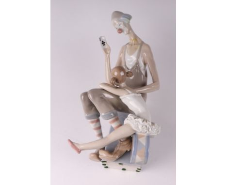 A Lladro figural group depicting a clown and a ballerina, 41cms high.Condition ReportThe clowns head has been detached at the