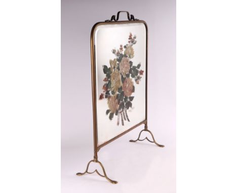 A brass fire screen with mirrored plate decorated with a spray of roses, 49cms wide.