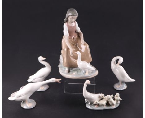 A Lladro Nao group, Goose Girl with Goose, 23cms high; together with four other Lladro Gosse figures (5).