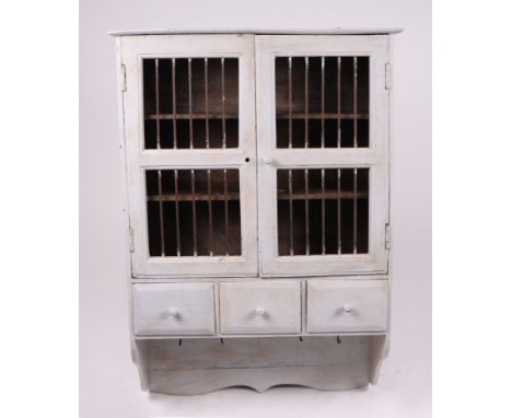 A painted pine wall hanging display cabinet, 64cms wide; together with a wrought iron boot rack, 62cms wide; a vintage enamel