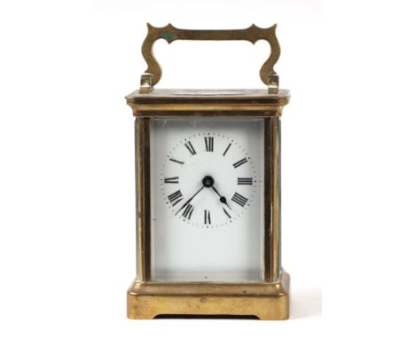 A brass carriage clock, the white enamel dial with Roman numerals, in a four-pillar case, 8cms wide.
