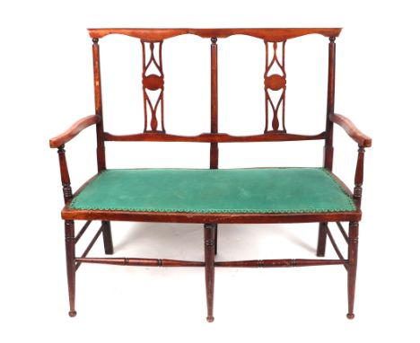 An Edwardian double chair-back two-seater sofa, on ring turned legs, 106cms wide.