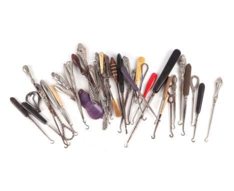 A large collection of button hooks to include silver handled examples.
