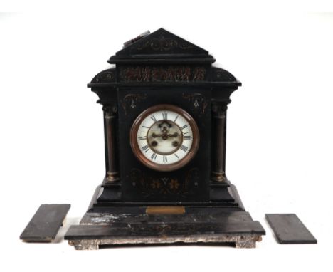 A Victorian architectural black slate mantle clock, the white enamel dial with open escarpment and Roman numerals, 37cms wide