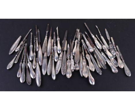A large quantity of manicure tools and button hooks, mainly silver handled, 