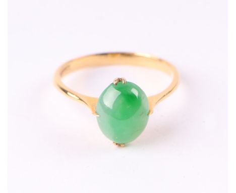 An 18ct gold ring set with an oval jade cabochon, approx UK size 'N', 2.4g.Condition ReportThere is a good repair and associa