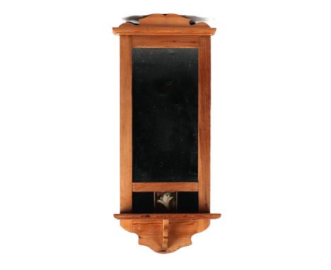 A stripped pine wall mirror inset with an Art Nouveau tile, 31cms wide by 81cms high.