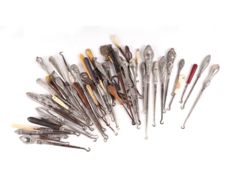 A large collection of button hooks to include silver handled examples.