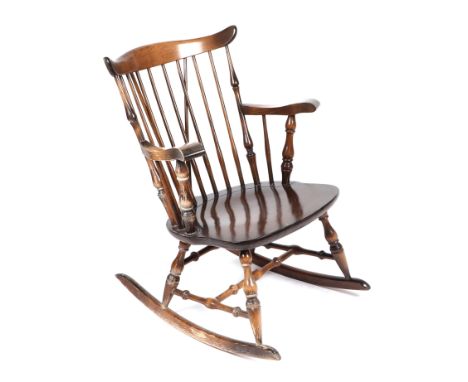 An Ercol style stained beech rocking chair.
