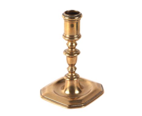 An early brass candlestick, 14cms high.Condition ReportThere is general wear to this piece, a small crease to the top circula