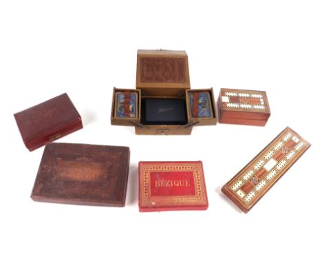 A quantity of vintage playing cards, cribbage boards, dominoes and similar items.